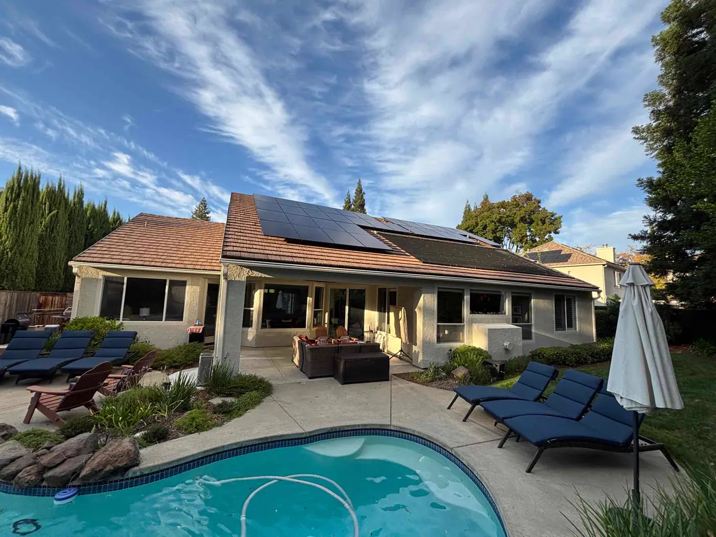 Rooftop solar panels on a single-story Northern California home, seen from the driveway